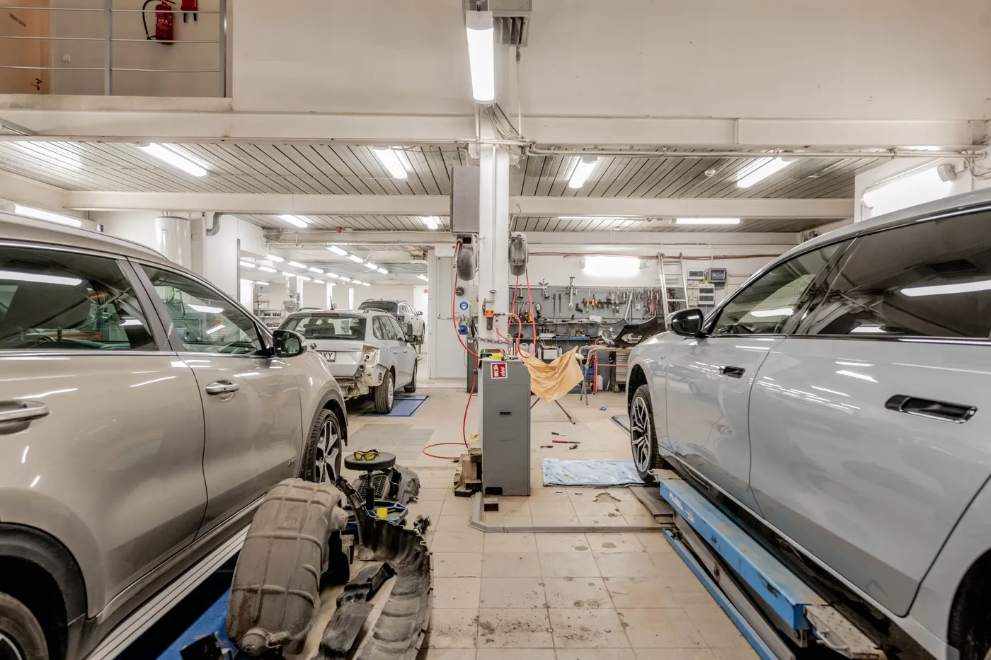 Workshop bay with cars up on hoists